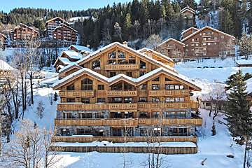 A large building with a lot of windows is covered in snow