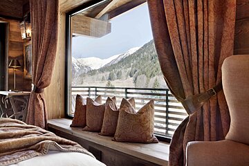 A window with a view of the mountains and trees