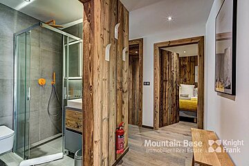 A bathroom with a fire extinguisher next to it that says mountain base