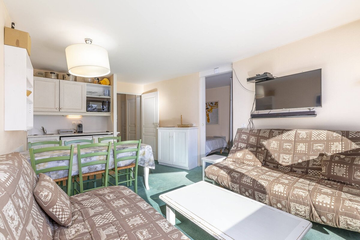 A living room with a couch a table and a flat screen tv