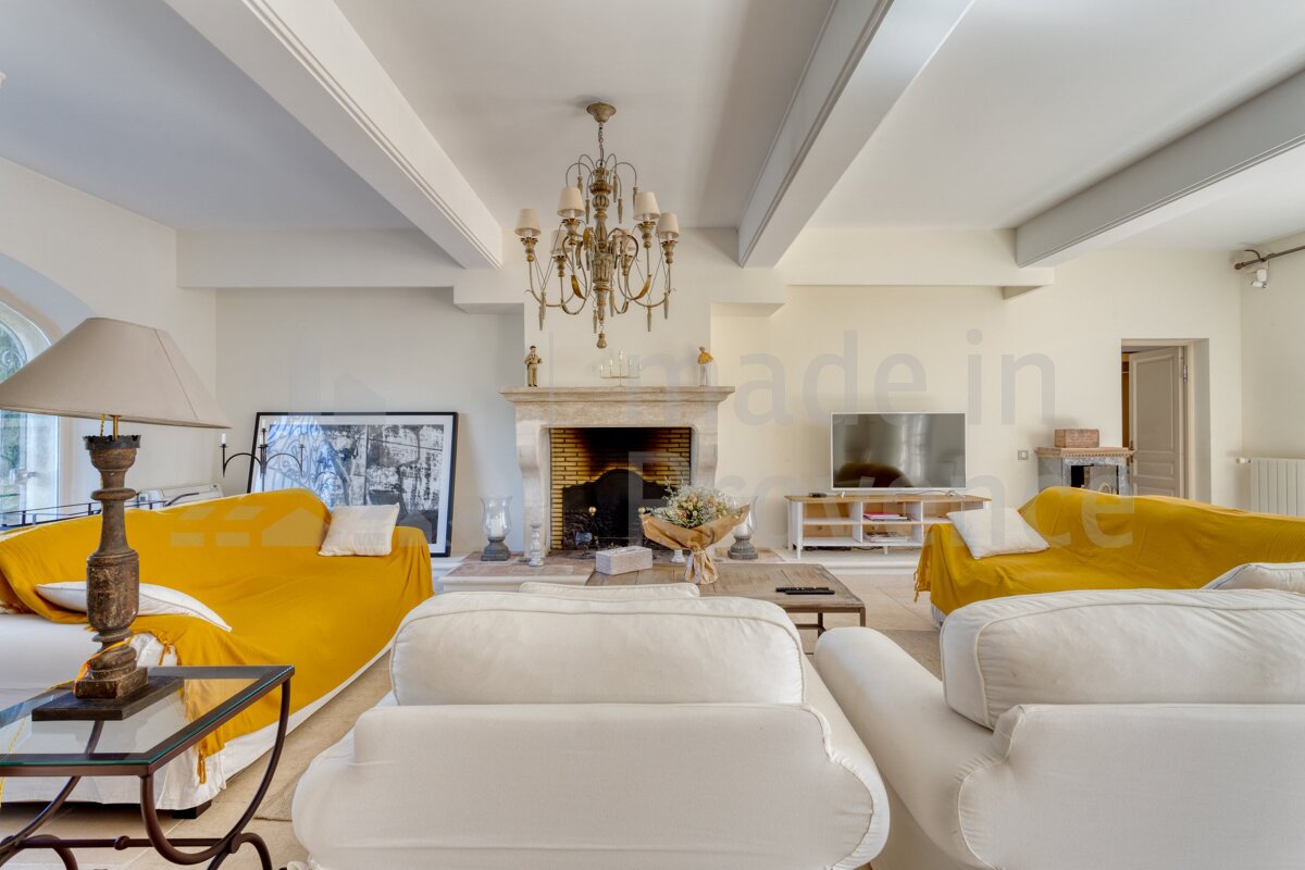 A living room with a yellow couch and a white couch