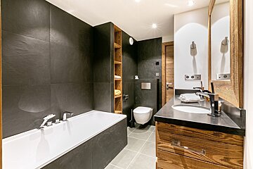 A bathroom with a bathtub a sink and a toilet