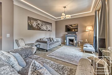 A living room with alpine property written on the corner