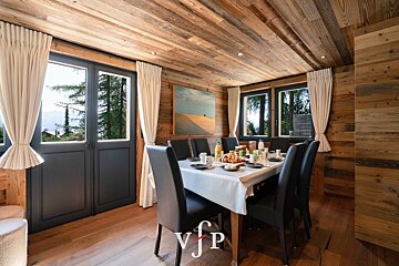 A dining room with a table and chairs and a sign that says vip