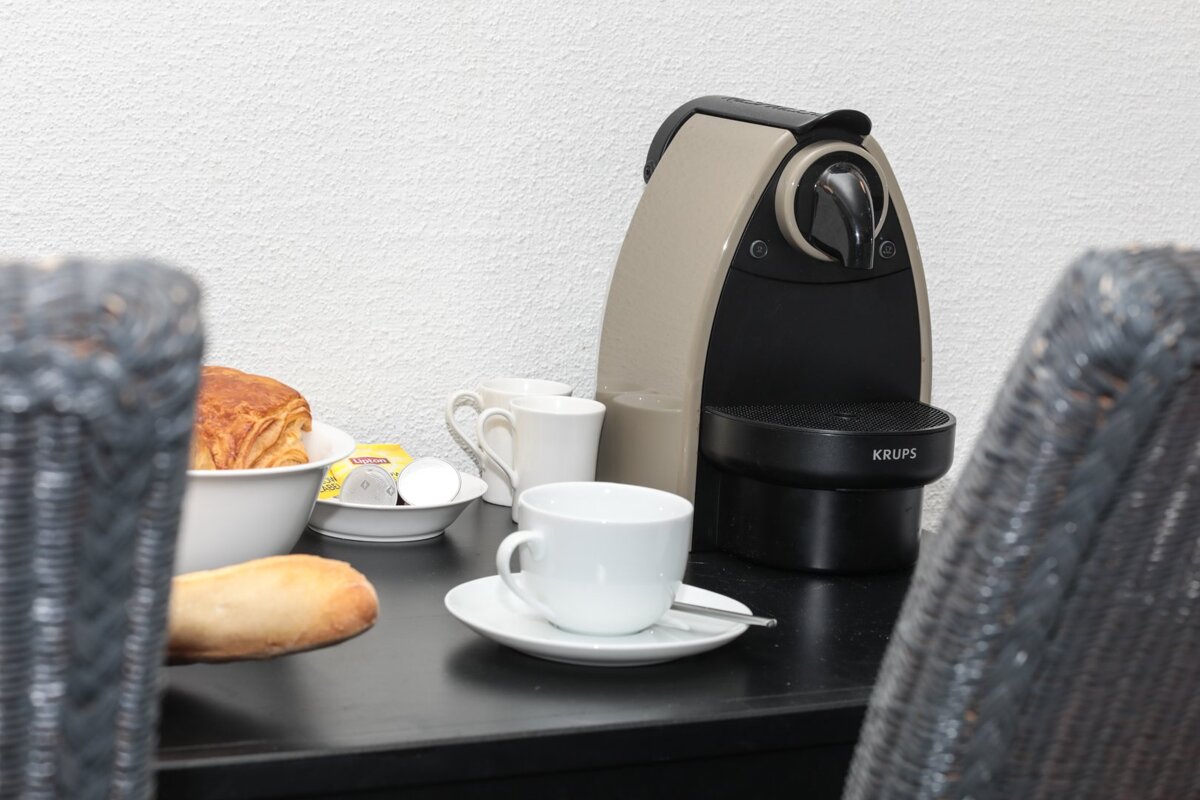 A krups coffee maker sits on a table