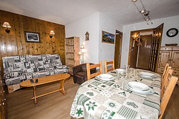 A living room with a couch and a table with plates on it
