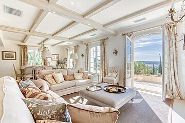 A living room with a couch ottoman and chairs