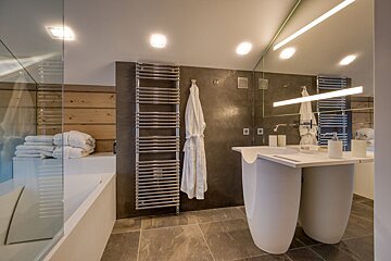 A bathroom with two sinks and a towel rack