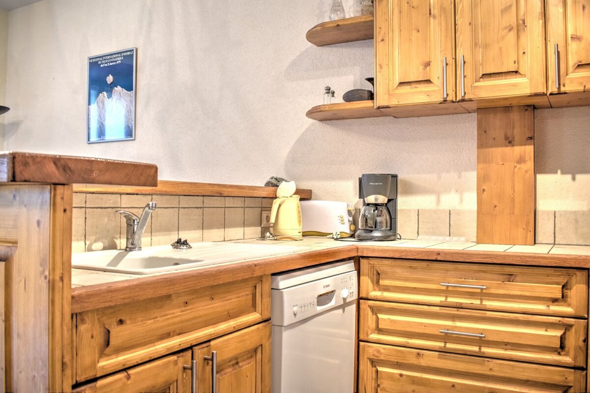 A kitchen with wooden cabinets and a dishwasher