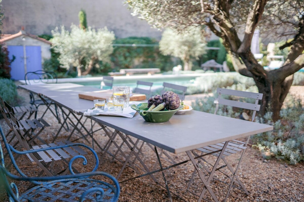 A table with a bowl of artichokes on it