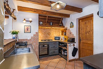 A kitchen with a picture of a bear on the wall