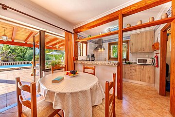 A kitchen with a table and chairs and a microwave