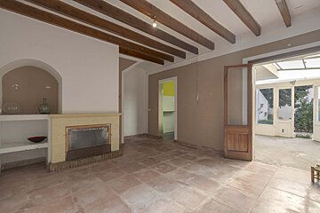 An empty room with a fireplace and a door