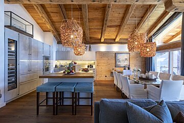 A kitchen and dining area with a painting on the wall