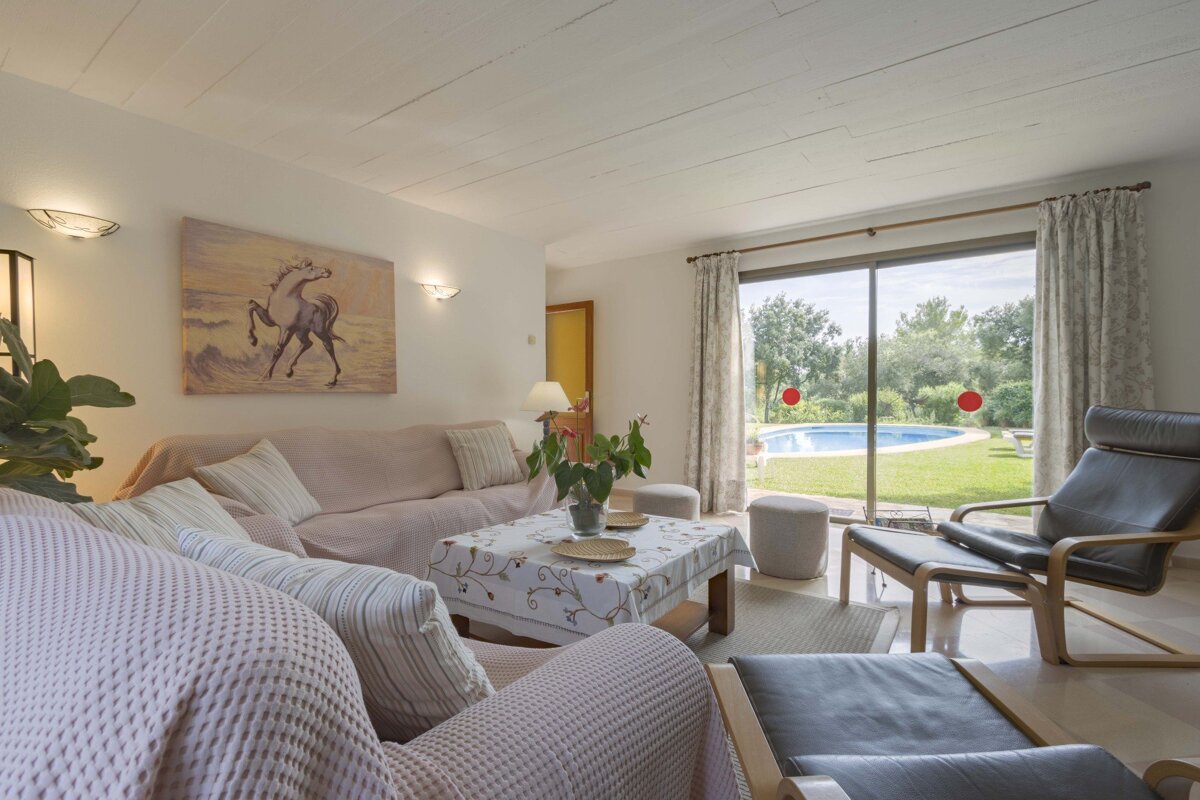 A living room with a painting of a horse on the wall