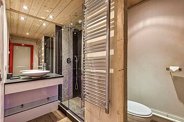 A bathroom with a toilet sink and a towel rack