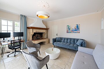 A living room with a couch and chairs and a fireplace