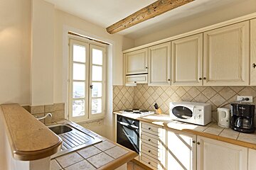 A kitchen with a microwave and a coffee maker