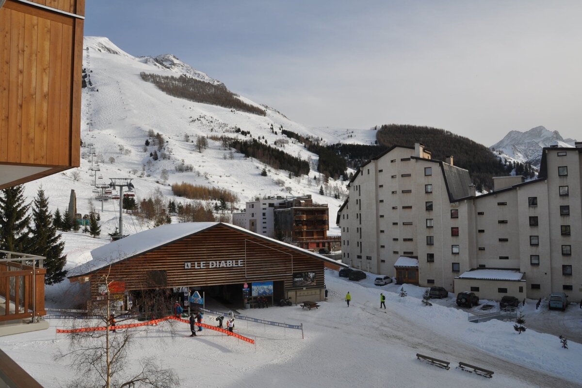 A snowy mountain ski resort with a chairlift, 