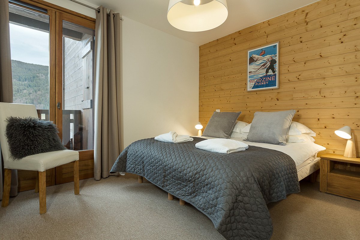 A bedroom with a bed and a picture on the wall that says magazine