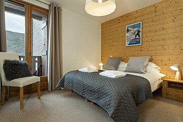 A bedroom with a bed and a picture on the wall that says magazine