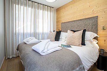 A bedroom with a bed and a book on it