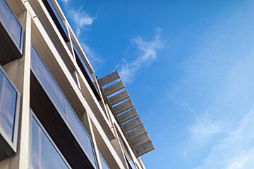 Looking up at a building with a blue sky in the background