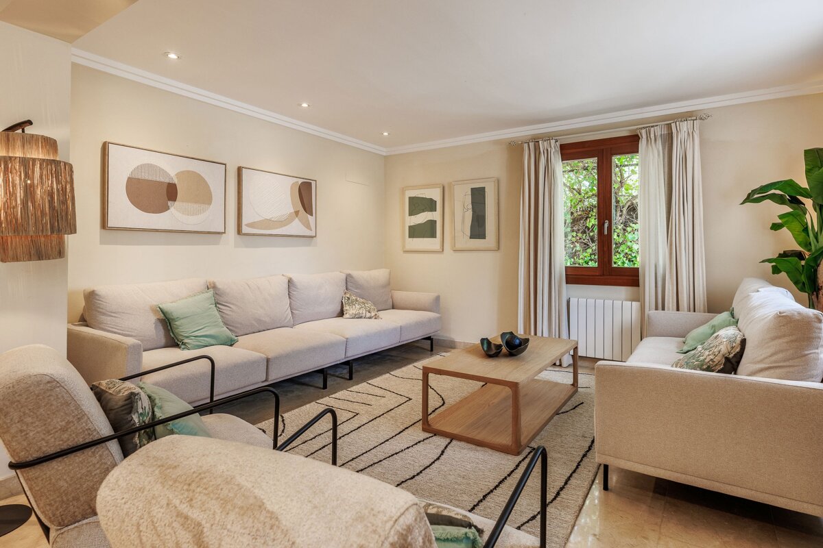 A living room with a couch and two chairs