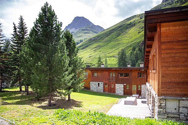 A wooden building with a mountain in the background