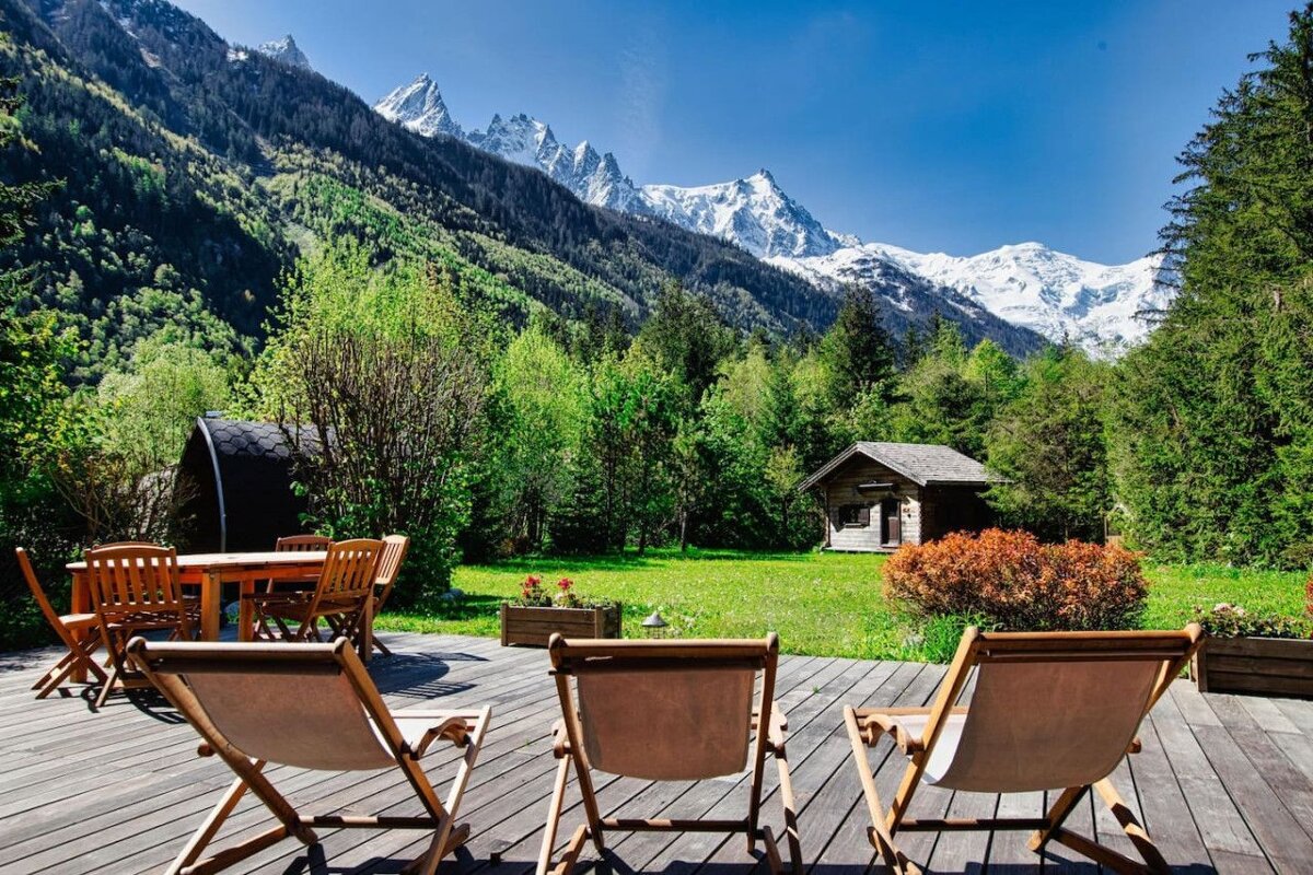 Chairs on a deck with mountains in the background