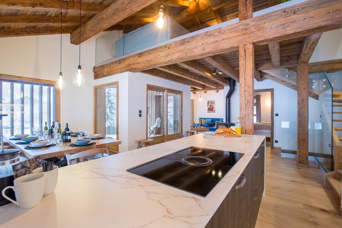 A kitchen with a stove top oven and a marble counter top