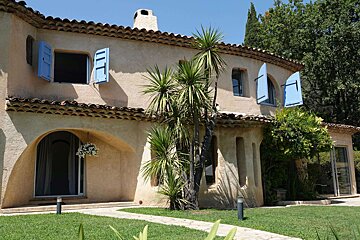 A house with blue shutters on the windows