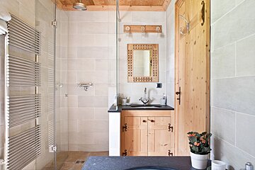 A bathroom with a sink and a mirror on the wall