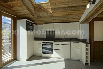 A kitchen with a skylight and the website immobilier.com