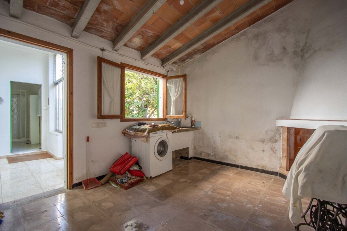 A room with a washing machine and a window