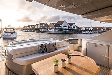A boat with a couch and a table in front of it