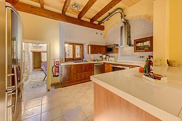 A kitchen with a fire extinguisher and a book on the counter