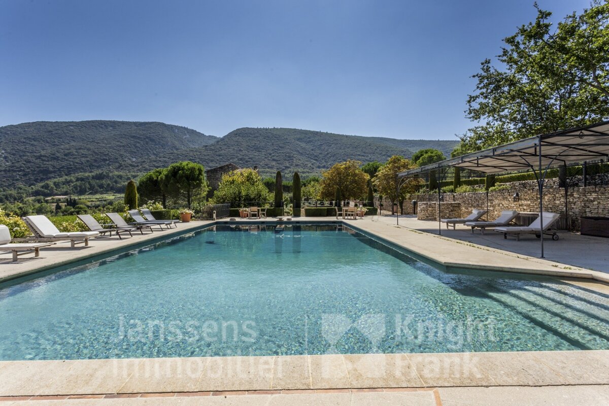 A large swimming pool is advertised by janssens immobilier