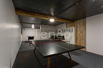 A ping pong table in a room with the word terroo on the wall