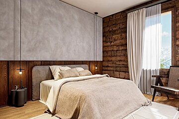 A rustic modern bedroom features a large bed with neutral bedding, a concrete-textured wall, dark wood paneling, and a window revealing a snowy mountain view.