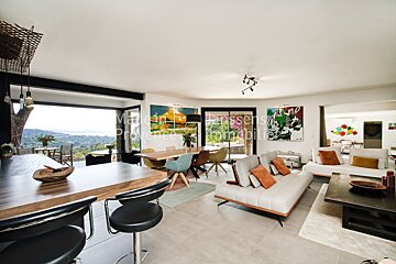 A living room with a couch and a dining table