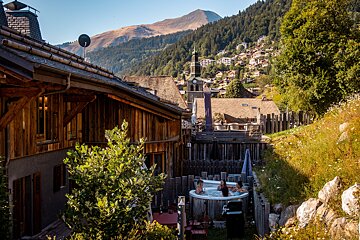 Two people in a hot tub with mountains in the background