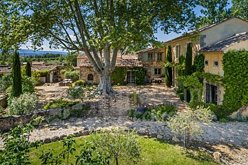 A large house with a large tree in front of it