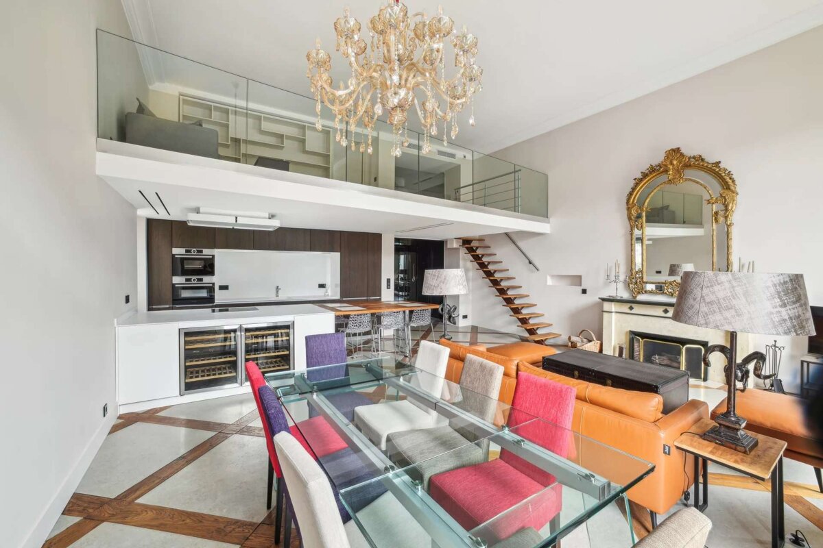 A dining room with a glass table and chairs