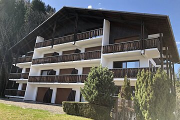 A large building with a mountain in the background