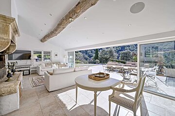 A living room with white furniture and a table
