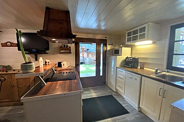 A kitchen with a sliding glass door leading to a backyard