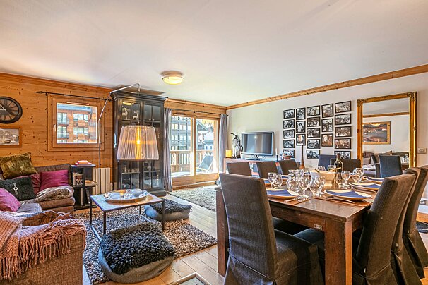 A living room with a dining table and chairs