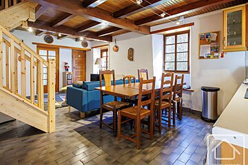A living room with a dining table and chairs
