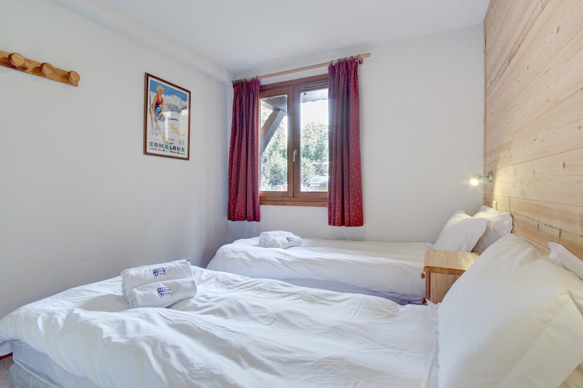 A bedroom with two beds and a picture on the wall that says ' salomon ' on it